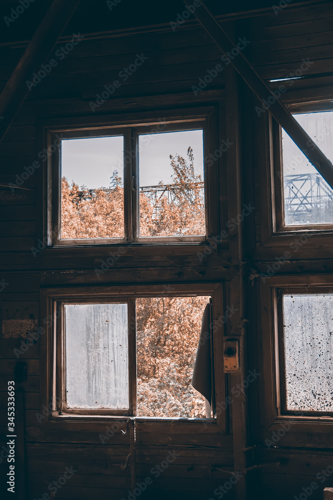 Fototapeta premium large broken window in an old destroyed building. Old ruined haunted house, abandoned house. The lost city of Pripyat. Chernobyl - image
