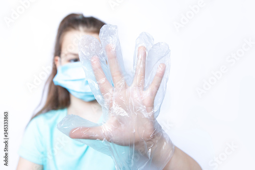Girl child wearing medical mask and disposable glove on white background
