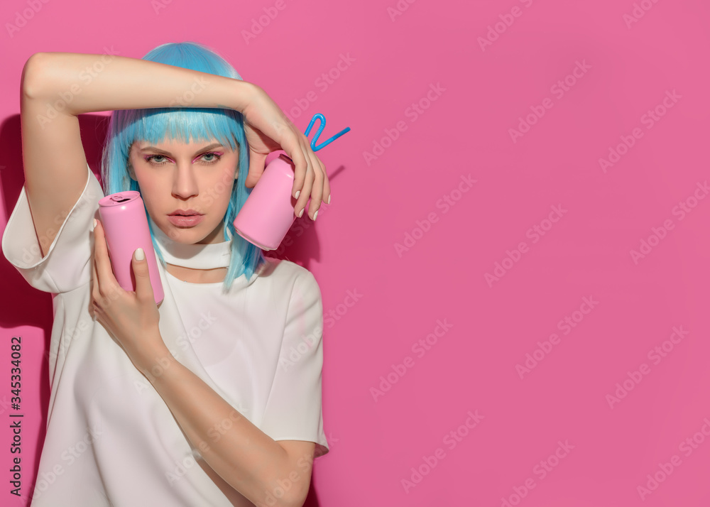 Portrait of young woman with blue hair holds in hands soda bottle on pink background. Pink metal aluminum beverage drink can. Summer boring, tedious party poster. Copy Space Portrait of young woman with blue hair holds in hands soda bottle on pink background. Pink metal aluminum beverage drink can. Summer boring, tedious party poster. Copy Space