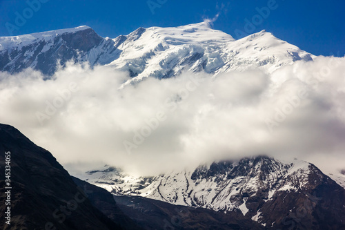 The snow capped Himalayan mountain peak of Mount Tukuche on the Annapurna Circuit in Nepal.