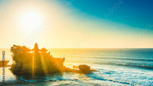 Breathtaking aerial view of of Tanah Lot Temple. Tanah Lot is a rock formation off the Indonesian island of Bali. It's home to the pilgrimage temple Pura Tanah Lot, a popular tourist and cultural icon