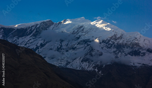 The snow capped mountain peak of Mount Tukuche on the Annapurna Circuit in Nepal.