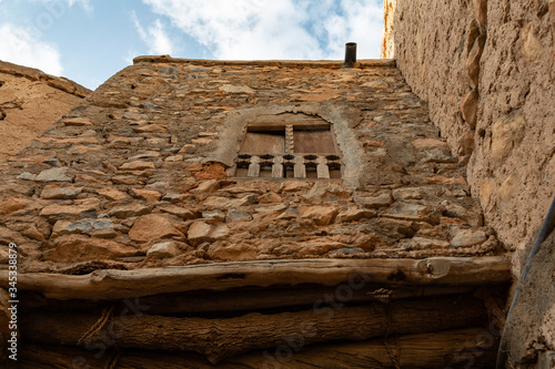 Upward view to a window in ruins of Misfat al Abriyeen village, Oman photo