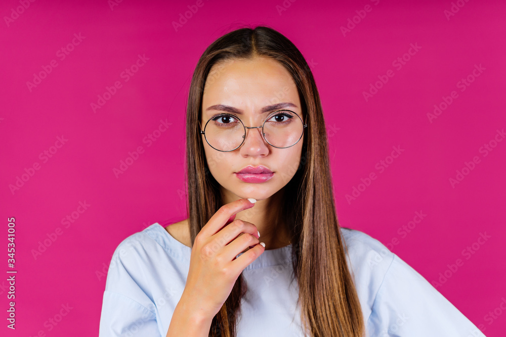 young teacher stares thoughtfully through glasses young teacher stares thoughtfully through glasses