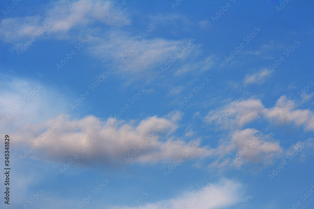 Small white clouds on dark blue background