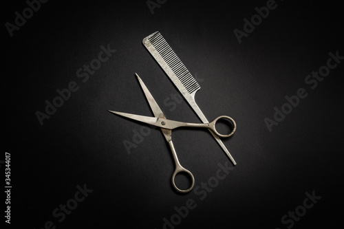 Nice old aluminum comb and steel scissors barber work instruments isolated photo