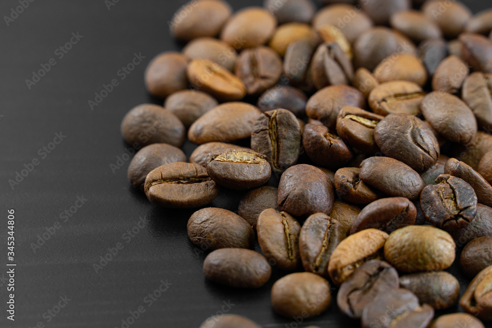 Coffee beans on a dark background macro Coffee beans on a dark background macro