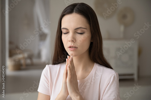 Superstitious young Caucasian woman hold hands in prayer ask beg God for better future or good luck, religious millennial female believer pray at home, feel blessed, faith, religion concept Free Download Superstitious young Caucasian woman hold hands in prayer ask beg God for better future or good luck, religious millennial female believer pray at home, feel blessed, faith, religion concept - GFXLoad