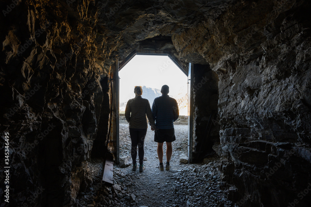 Couple Stands  In The Doorway of Ptarmigan Tunnel
