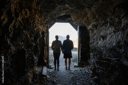Couple Stands In The Doorway of Ptarmigan Tunnel
