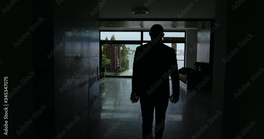 Unrecognizable man with alcohol walking through spacious room Unrecognizable man with alcohol walking through spacious room