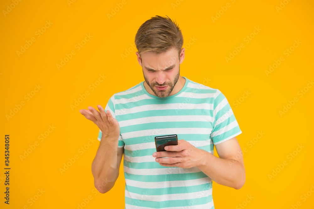 SMS mobile communication. Handsome man read on mobile phone. Mobile news. Handheld mobile device. Touchscreen interface with digital buttons. Modern life. New technology. High tech products. 3G. 4G