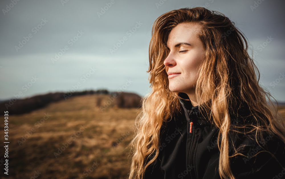 Happy young woman with long hair lifestyle portrait outdoor