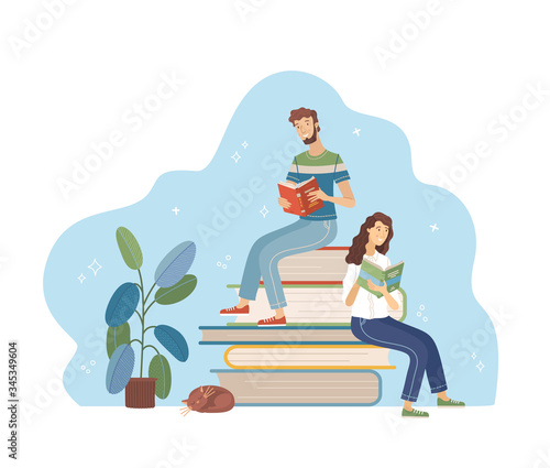 Young man and woman reading while sitting on stack of big books