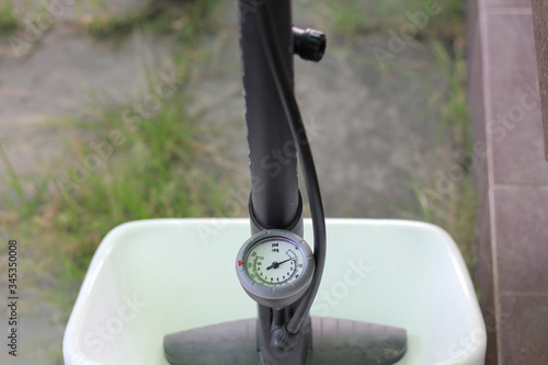 close up Manual air pump with barometer on blur background