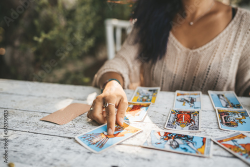 Close uo of female hands with Tarot cards photo