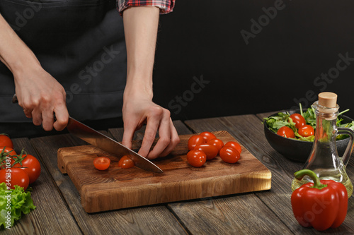 Woman cooking fresh vegetable salad. Female hands. Diet concept for healthy lifestyle with copyspace.