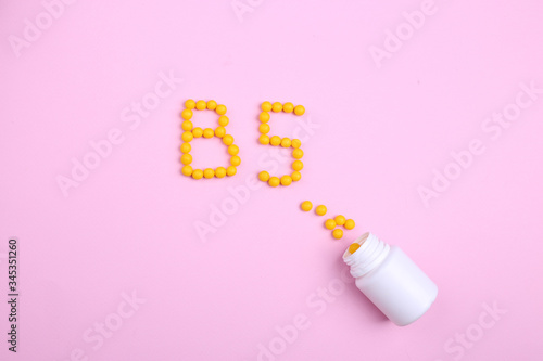 Creative healthcare and medicine concept picture vitamins like the letter B5 on a pink background 