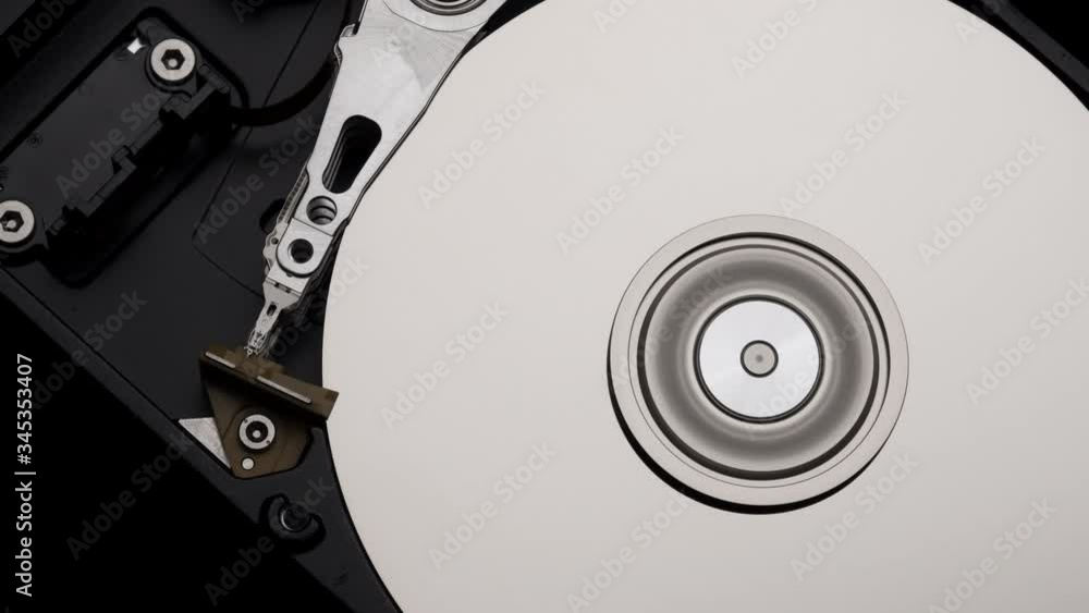 Macro, Close-Up of Computer Hard Disk Drive Spinning and Writing then Rotation Slow Down. 4k Macro, Close-Up of Computer Hard Disk Drive Spinning and Writing then Rotation Slow Down. 4k