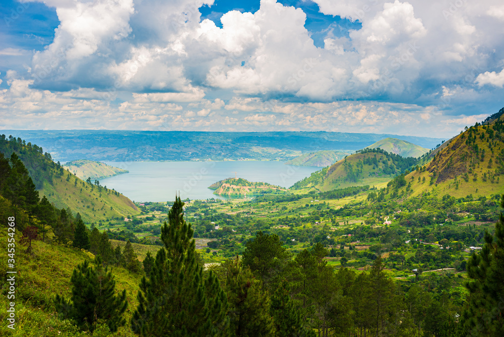 Lake Toba and Samosir Island view from above Sumatra Indonesia. Huge volcanic caldera covered by water, traditional Batak villages, green rice paddies, equatorial forest.