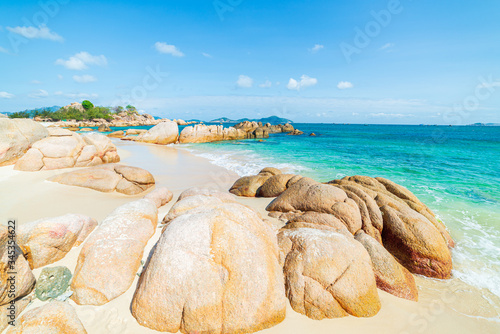 Fototapeta Naklejka Na Ścianę i Meble -  Gorgeous tropical beach turquoise transparent water unique rock boulders, Cam Ranh Nha Trang Vietnam south east coast travel destination, desert beach no people clear blue sky