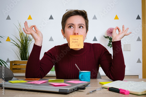 Woman having a brainstorm while telecommuting from home on her laptop
 photo