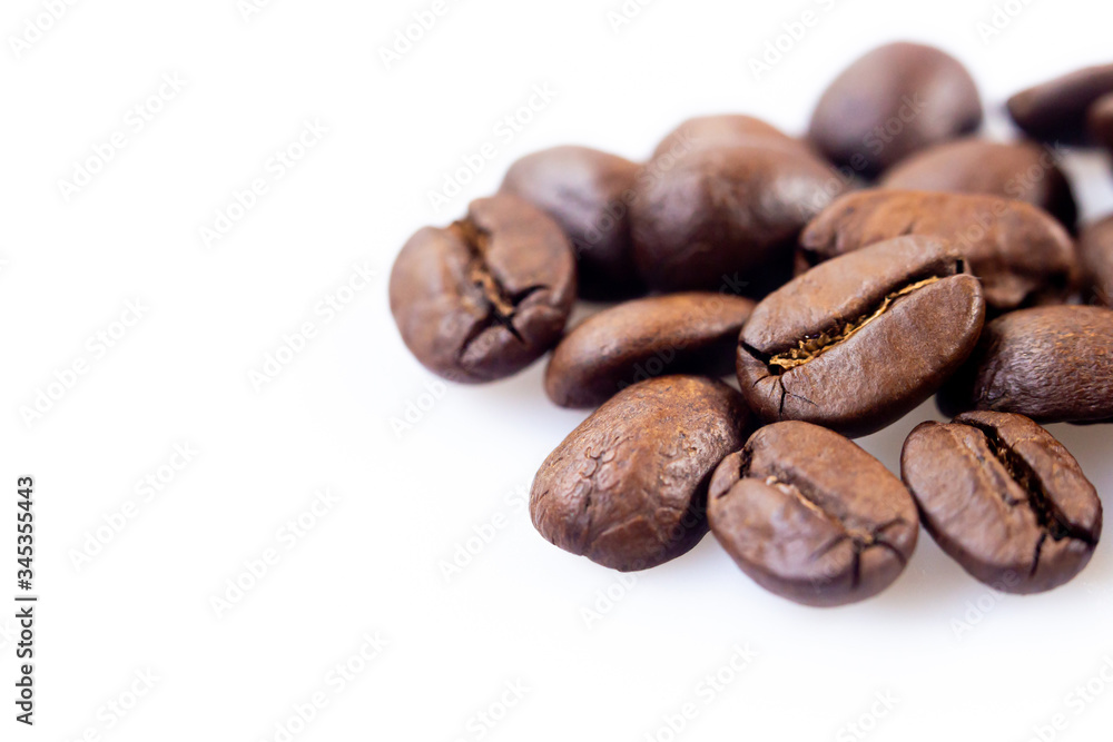 Roasted coffee beans close up ,isolated in white background Roasted coffee beans close up ,isolated in white background