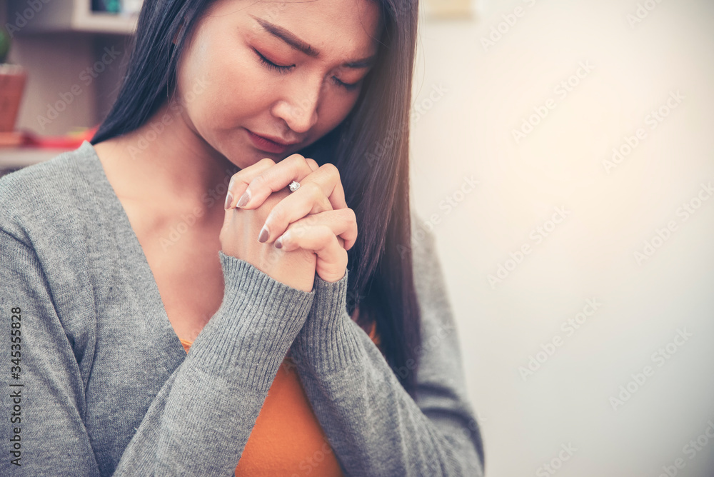 Prayer and bible concept. Asian female praying, hope for peace and free from coronavirus, Hand in hand together by woman, believes and faith in christian religion at church. Prayer and bible concept. Asian female praying, hope for peace and free from coronavirus, Hand in hand together by woman, believes and faith in christian religion at church.