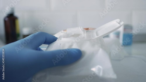 Slow Motion with Hands Protected with Gloves Using Wet Wipes for Disinfecting and Cleaning