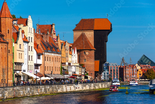 Gdansk old city in Poland with the oldest medieval port crane Zuraw and promenade along riverbank of Motlawa River