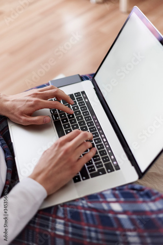 Hands typing on a laptop 