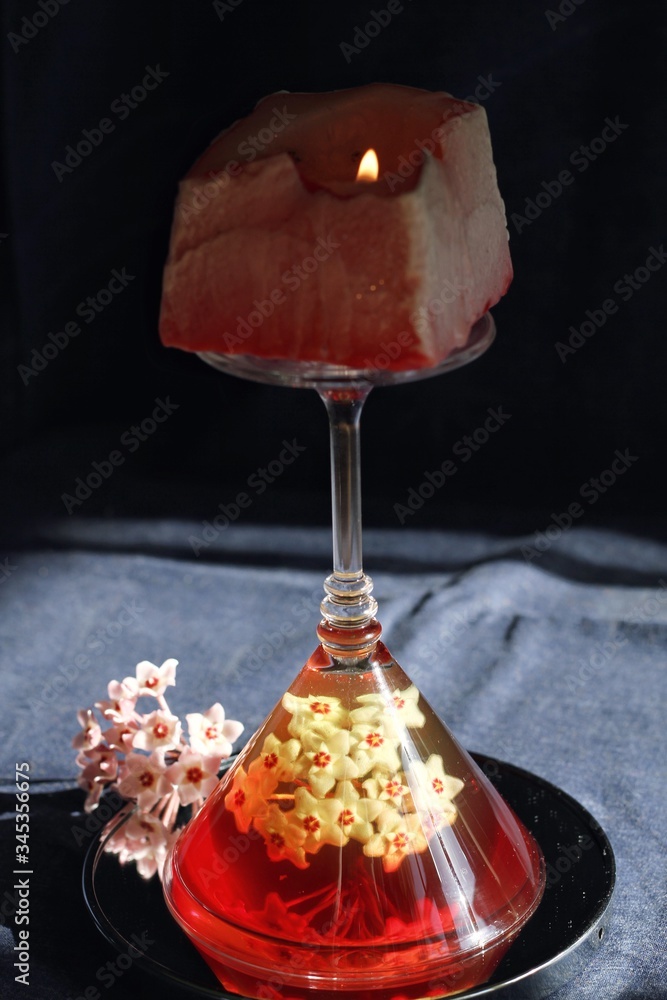 Sweet jelly dessert, design food, creative meals with vanilla flowers in dark mood on black background