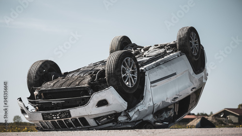 Cuadro en lienzo Horrific Traffic Accident, Rollover Smoking and Burning Vehicle Lying on its Roof in the Middle of the Road after Collision