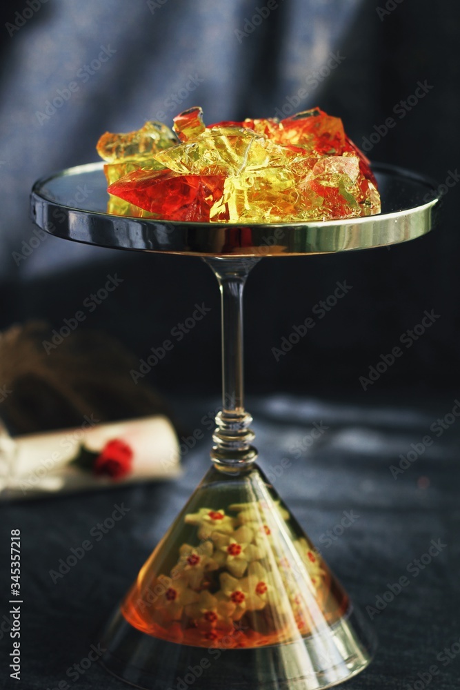 Sweet jelly dessert, design food, creative meals with vanilla flowers in dark mood on black background