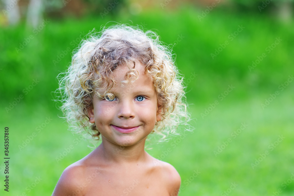 Portrait of a curly white boy in the park Portrait of a curly white boy in the park