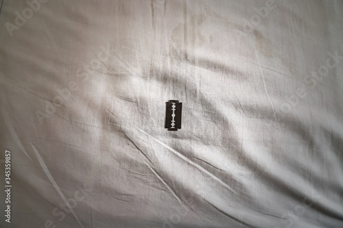 Razor Blade on Bedsheet for Bridal Night, Female Genital Mutilation photo