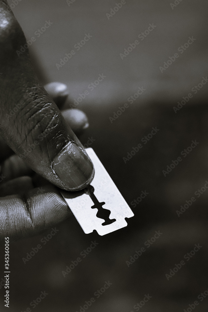 Black Hands Holding Razor Blades for Circumcision Stock Photo | Adobe Stock