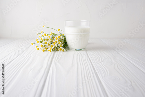 Homemade probiotic kefir drink or yogurt with probiotics in glasses on a white wooden background with copy space