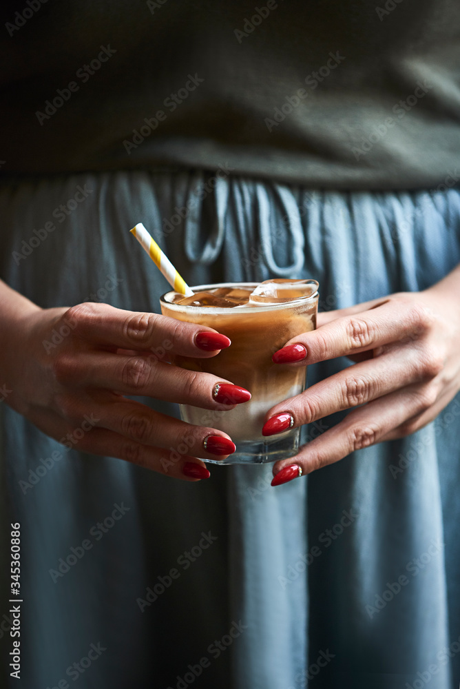 Woman holding ice coffee