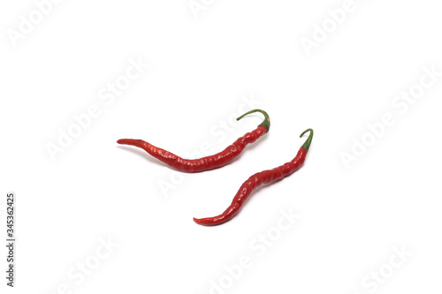 Two curly red chillies (Capisicum annuum) top high angle isolated on white background