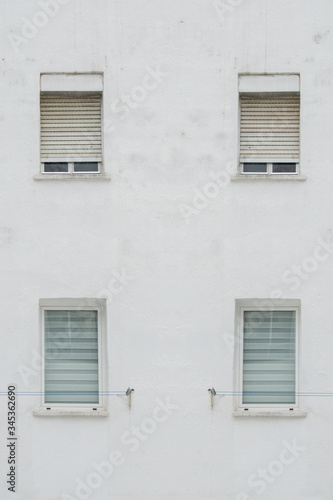 white facade with four symmetrical windows