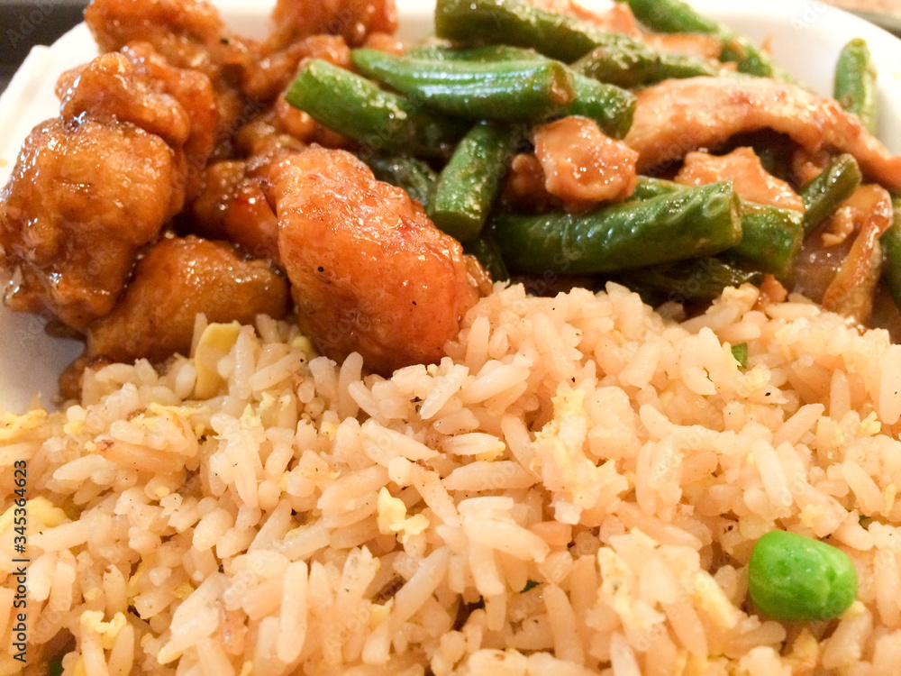 Chinese takeout food orange chicken green beans fried rice close up