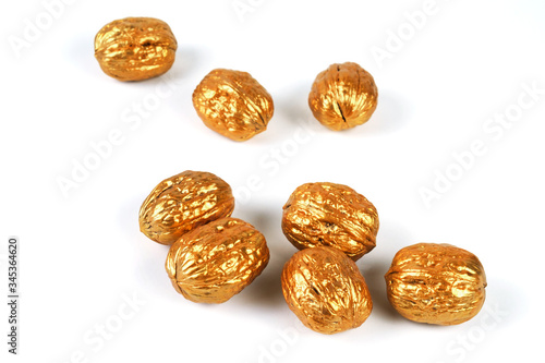 Group of golden walnuts on a white background