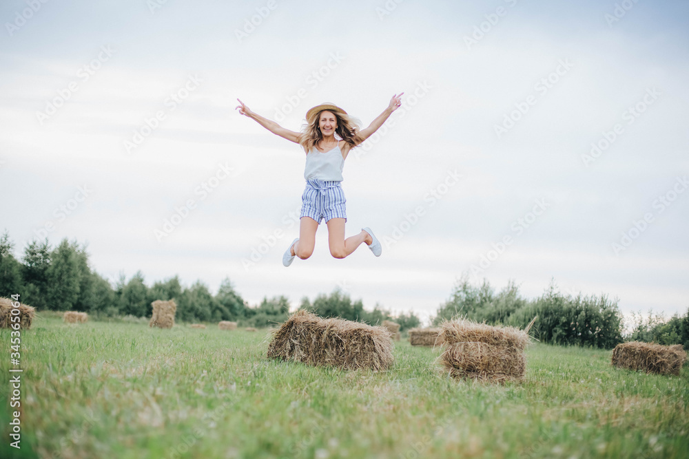 beautiful girl in a straw hat on a field with straw bales. girl sitting on the hay. blonde in the summer in a field with a hat. life in the countryside, outdoors. eco project. clean environment beautiful girl in a straw hat on a field with straw bales. girl sitting on the hay. blonde in the summer in a field with a hat. life in the countryside, outdoors. eco project. clean environment