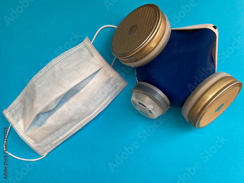 protective respirator with filters, medical white mask on a blue background.