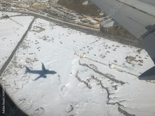 airplane shadow in the snow - aerial view