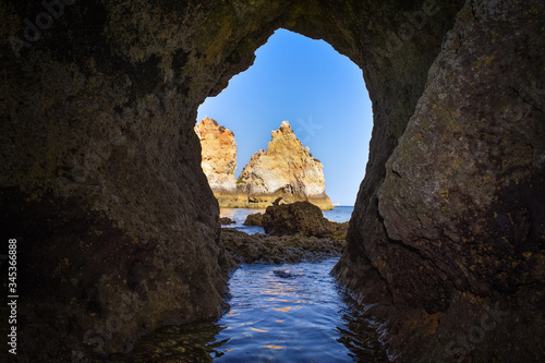 Natural archway through which you can see the sea. Uncrowded travel concept. Algarve, Portugal. Algarve, Portugal © dhvstockphoto