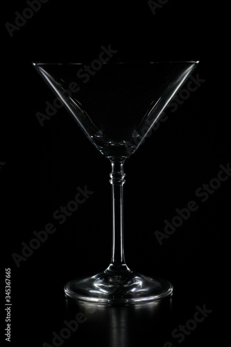 Cocktail glass silhouette outlined with light and with black background