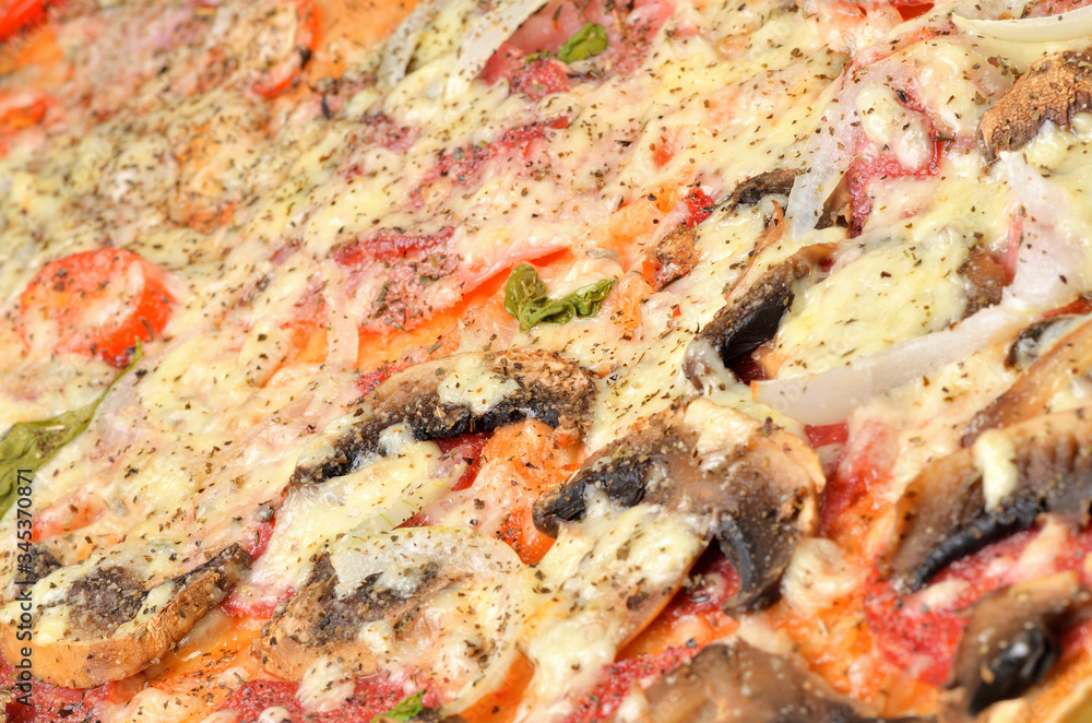 Fresh baked homemade pizza with mushrooms, onions, Gouda cheese, basil, oregano and tomato sauce. Macro. Fresh baked homemade pizza with mushrooms, onions, Gouda cheese, basil, oregano and tomato sauce. Macro.