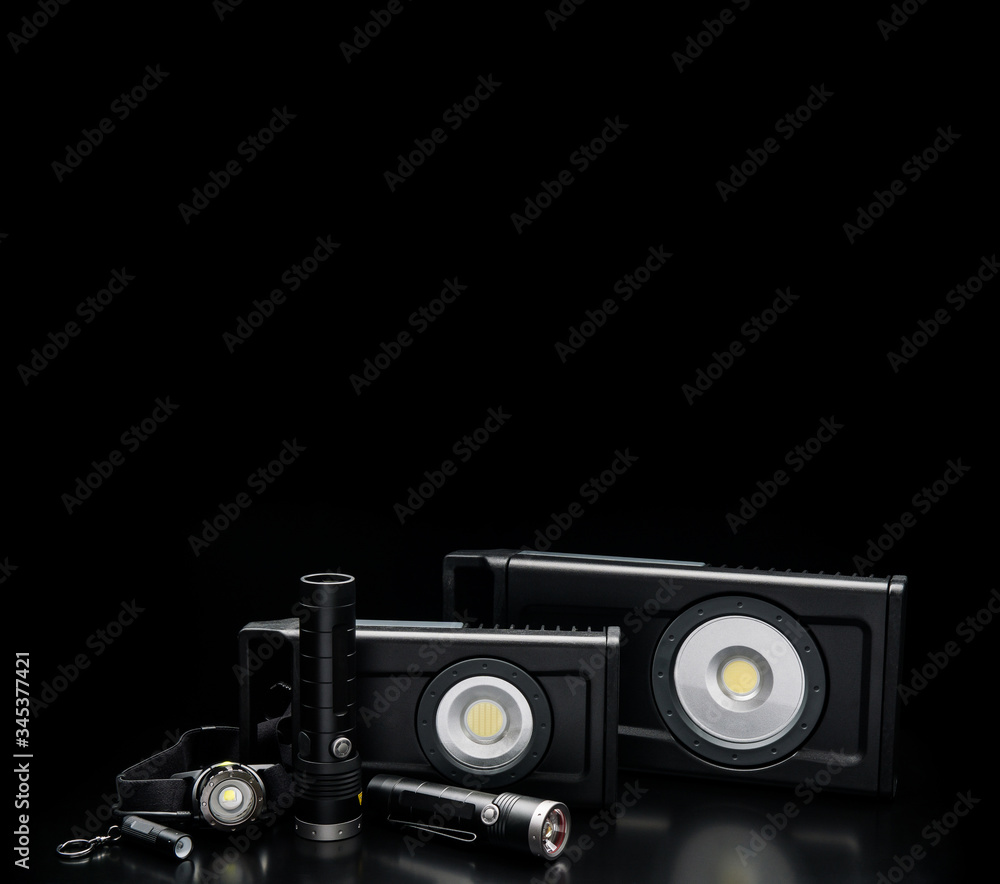 LED flashlights on a black back. Modern portable lighting.
